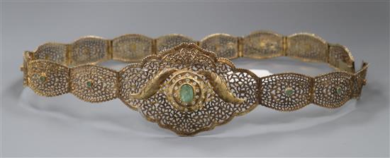 A Middle Eastern pierced gilt white metal, paste and green gem set belt, approx. 82cm.